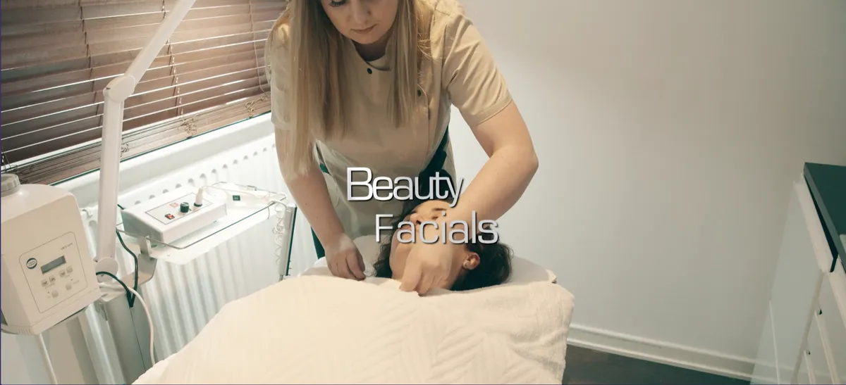Beauty Facials page header: a cosmetician giving a client a facial treatment in the salon, with the title “Beauty Facials” in thin white type