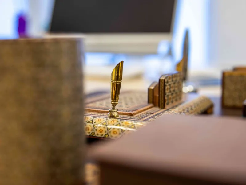 Close-up of the inlaid wooden desk set and pen holder in the consultation room