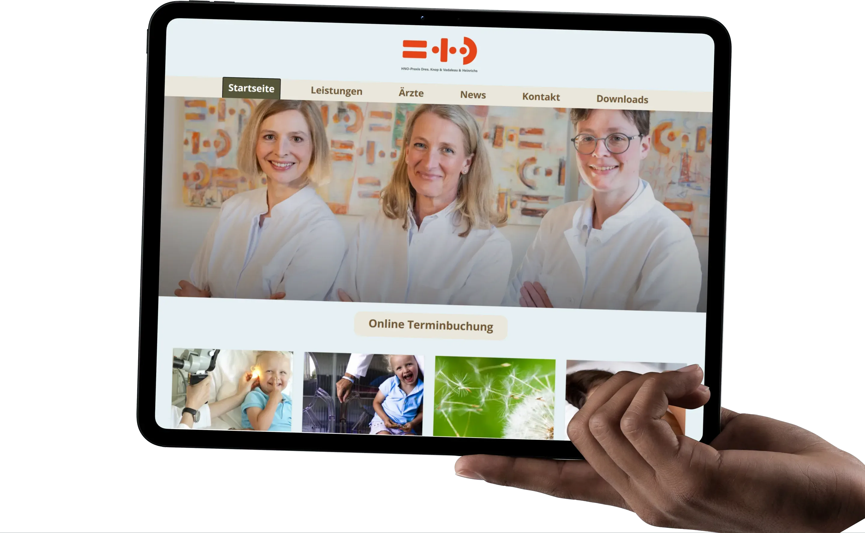 Hand holding a tablet with the HNO in Eppendorf home page: the practice's three ENT doctors, the Leistungen, Ärzte and Kontakt navigation and the Online-Terminbuchung button