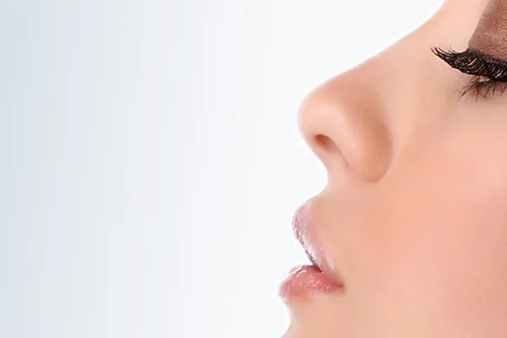 Side profile of a woman’s nose against a white background